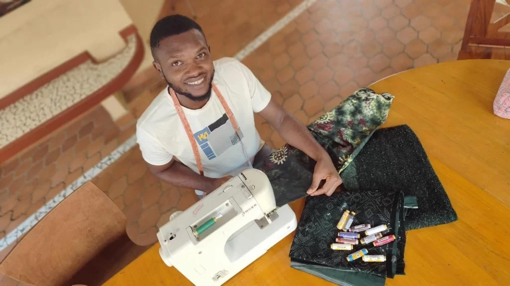 Blaise working on a sewing machine