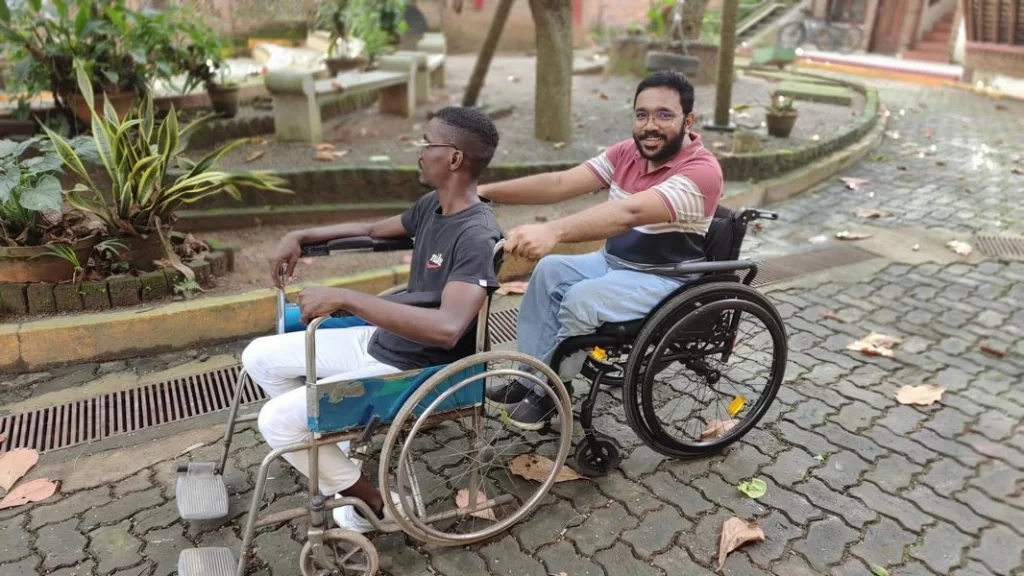 sijo and his beneficiary on wheel chair