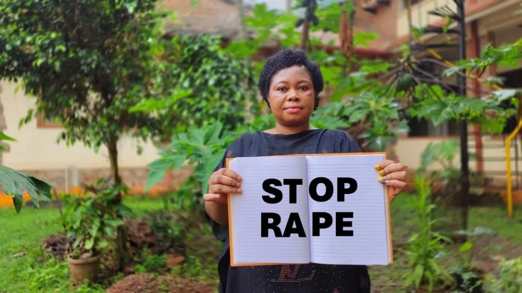 solange hlding a banner saying "stop rape "