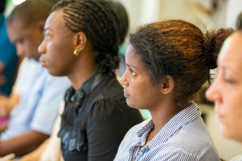 Participants watching at a speech with serious face